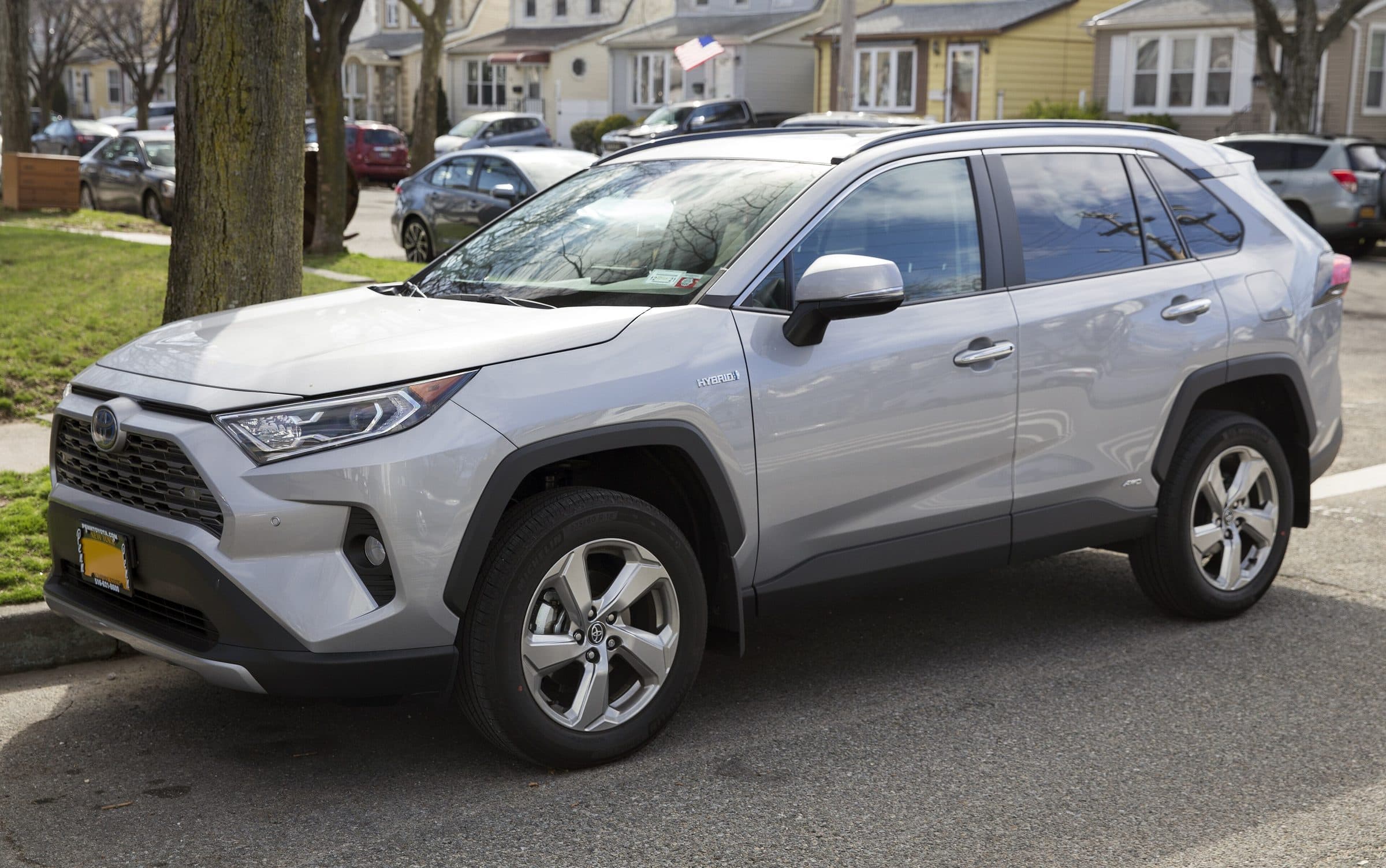 Silver Sky Metallic Toyota RAV4 Hybrid Limited parked on a New York residential street