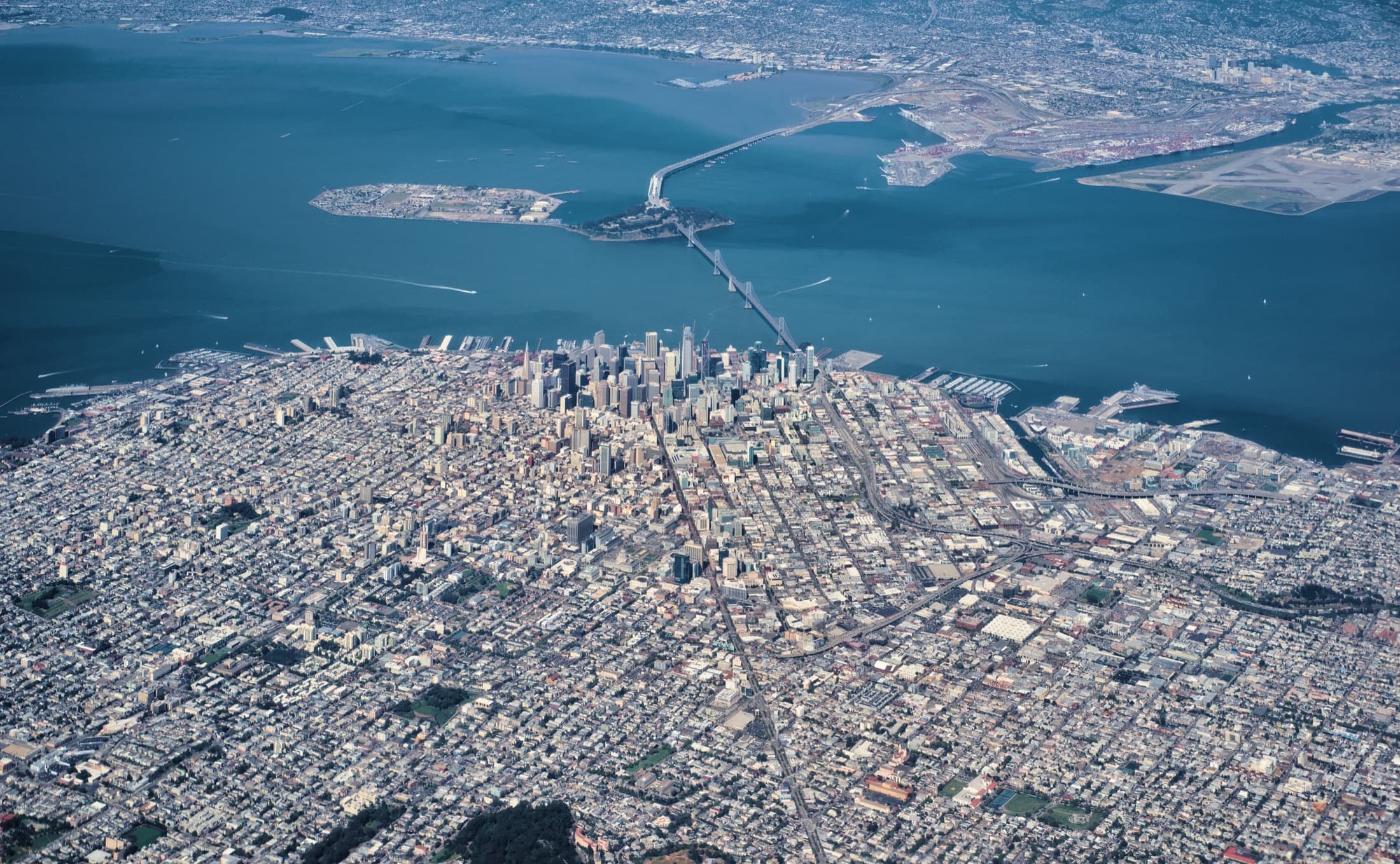 Aerial view of downtown San Francisco, the Bay Bridge, Treasure Island, and Oakland