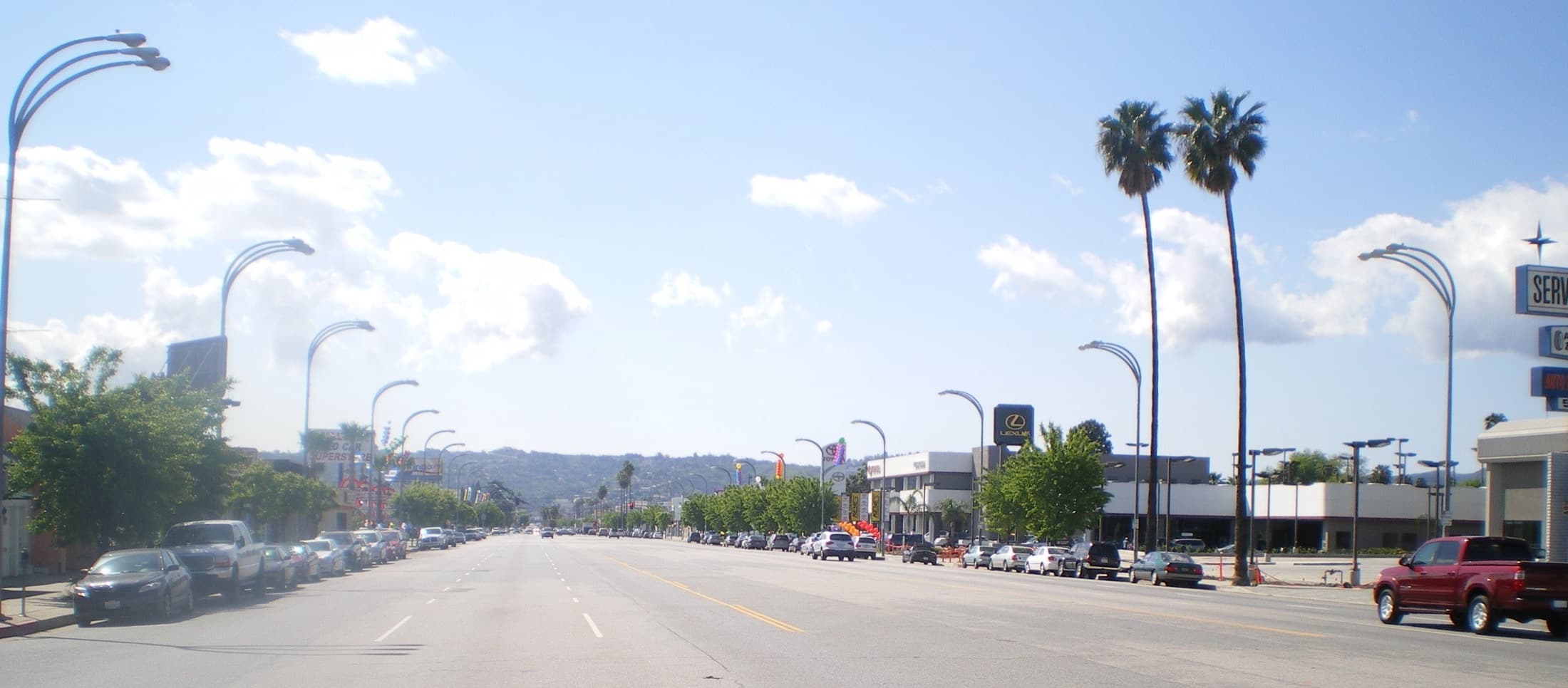 Van Nuys Boulevard street scene with businesses and traffic under a clear sky