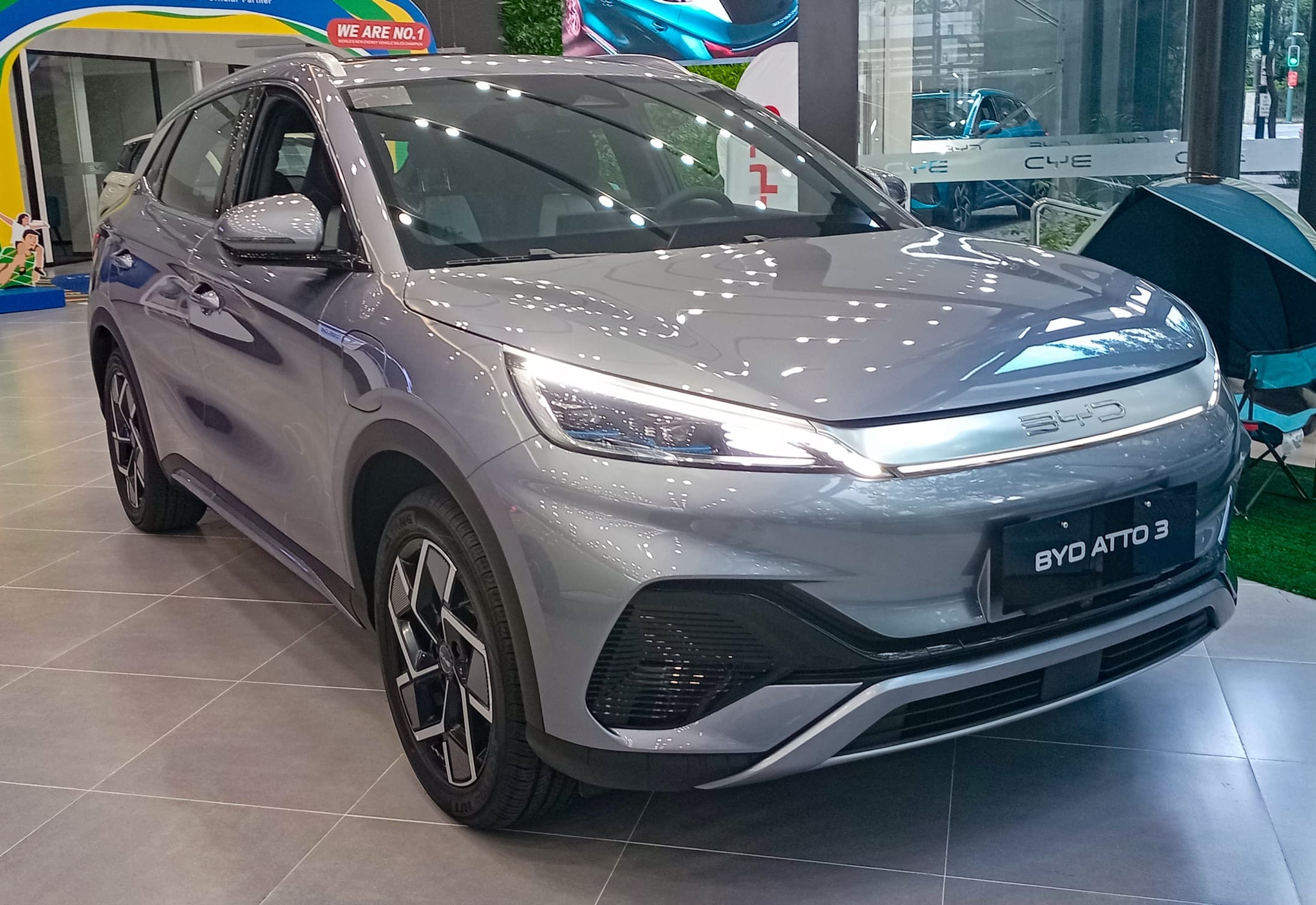 Gray 2024 BYD Atto 3 electric SUV on display in a showroom