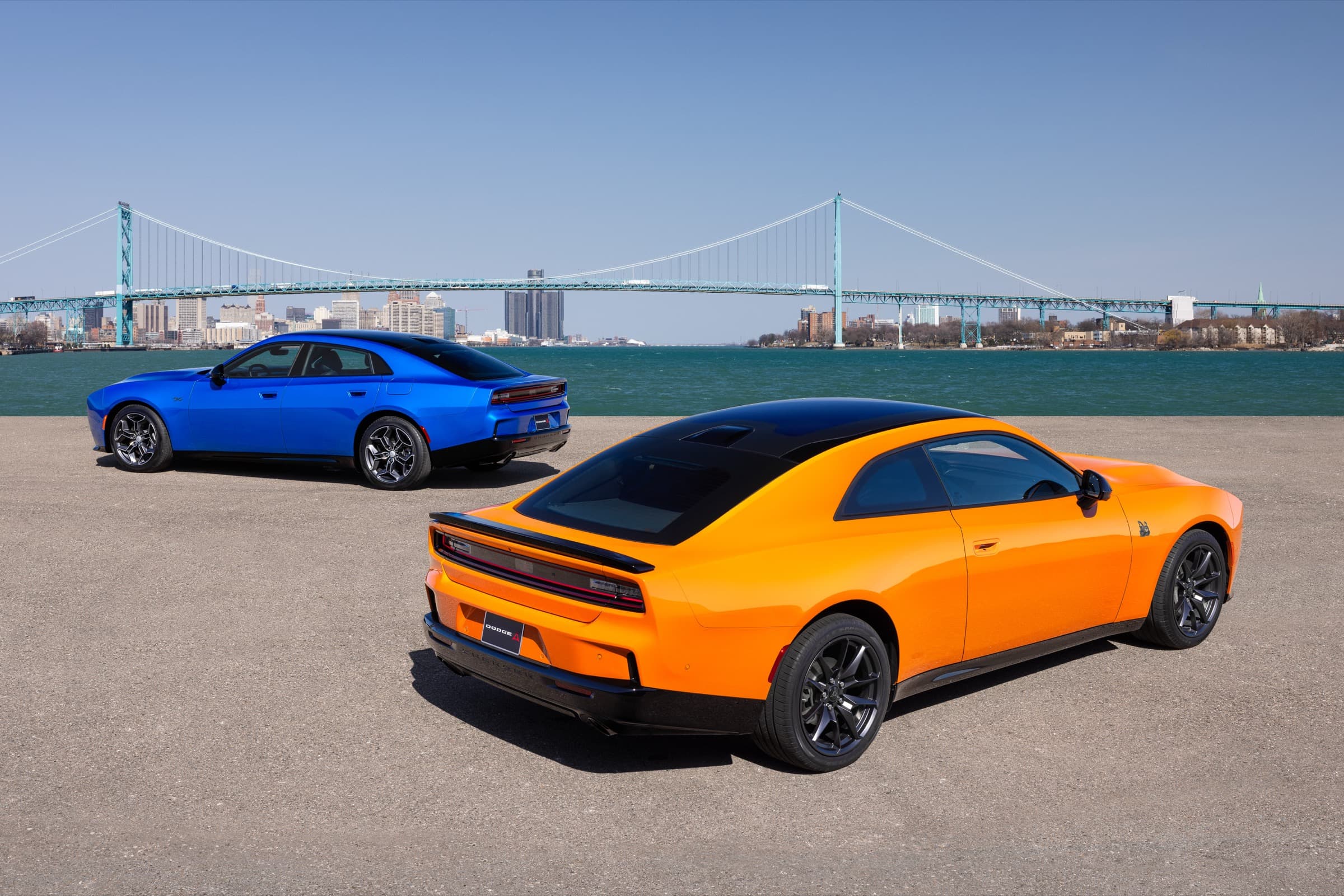2026 Dodge Charger Scat Pack and Charger R/T parked on wet pavement