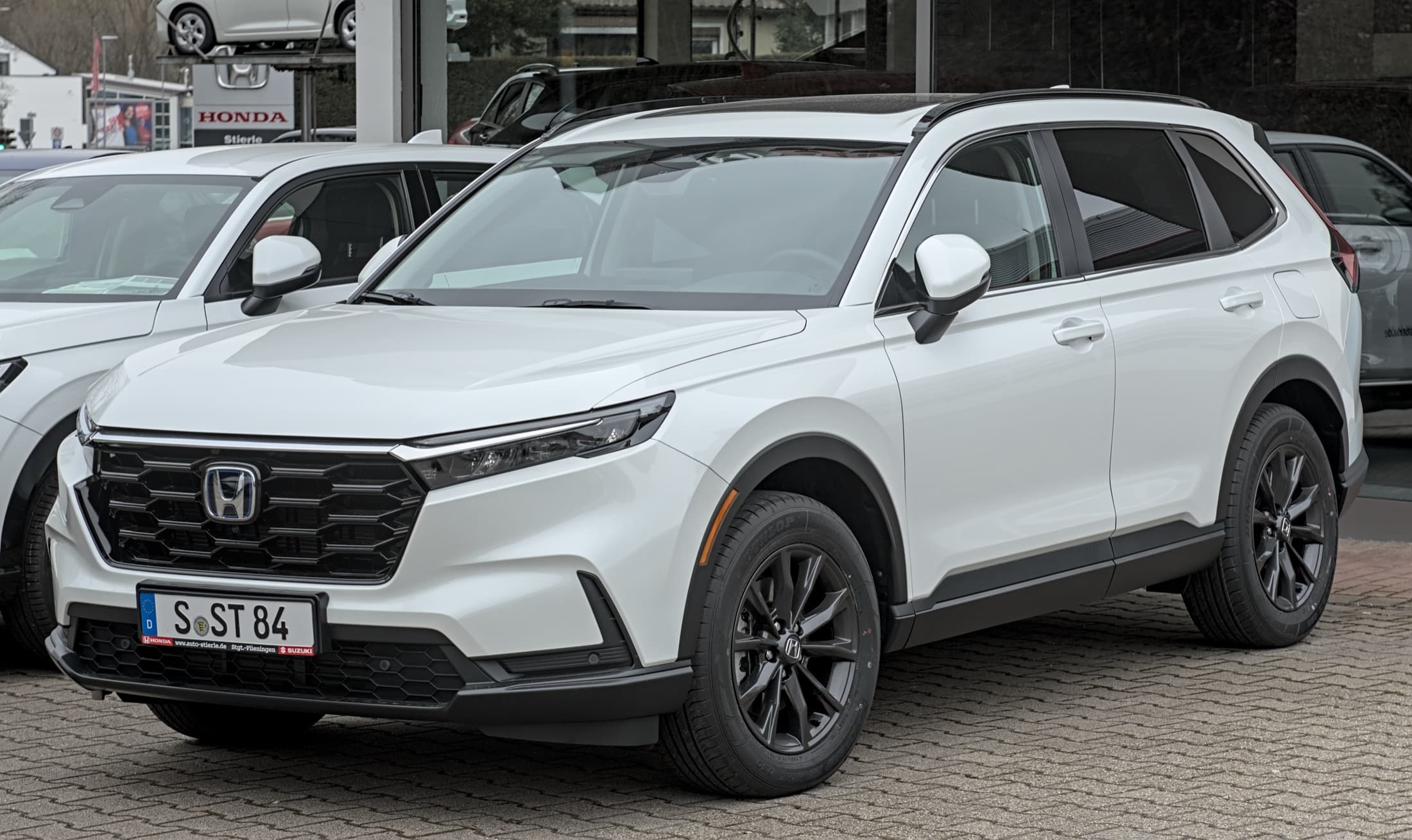 White Honda CR-V Hybrid parked outdoors, front three-quarter view