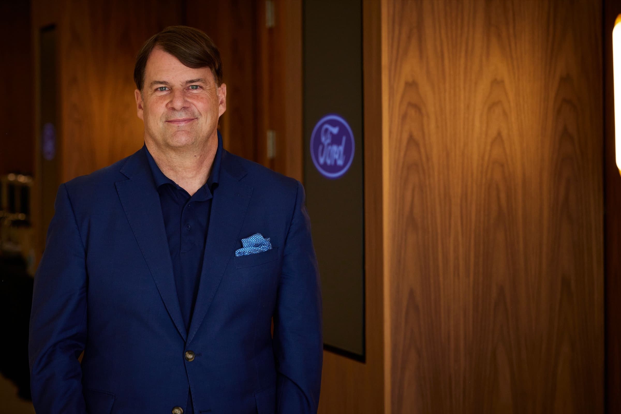 Ford CEO Jim Farley in a navy blazer, portrait