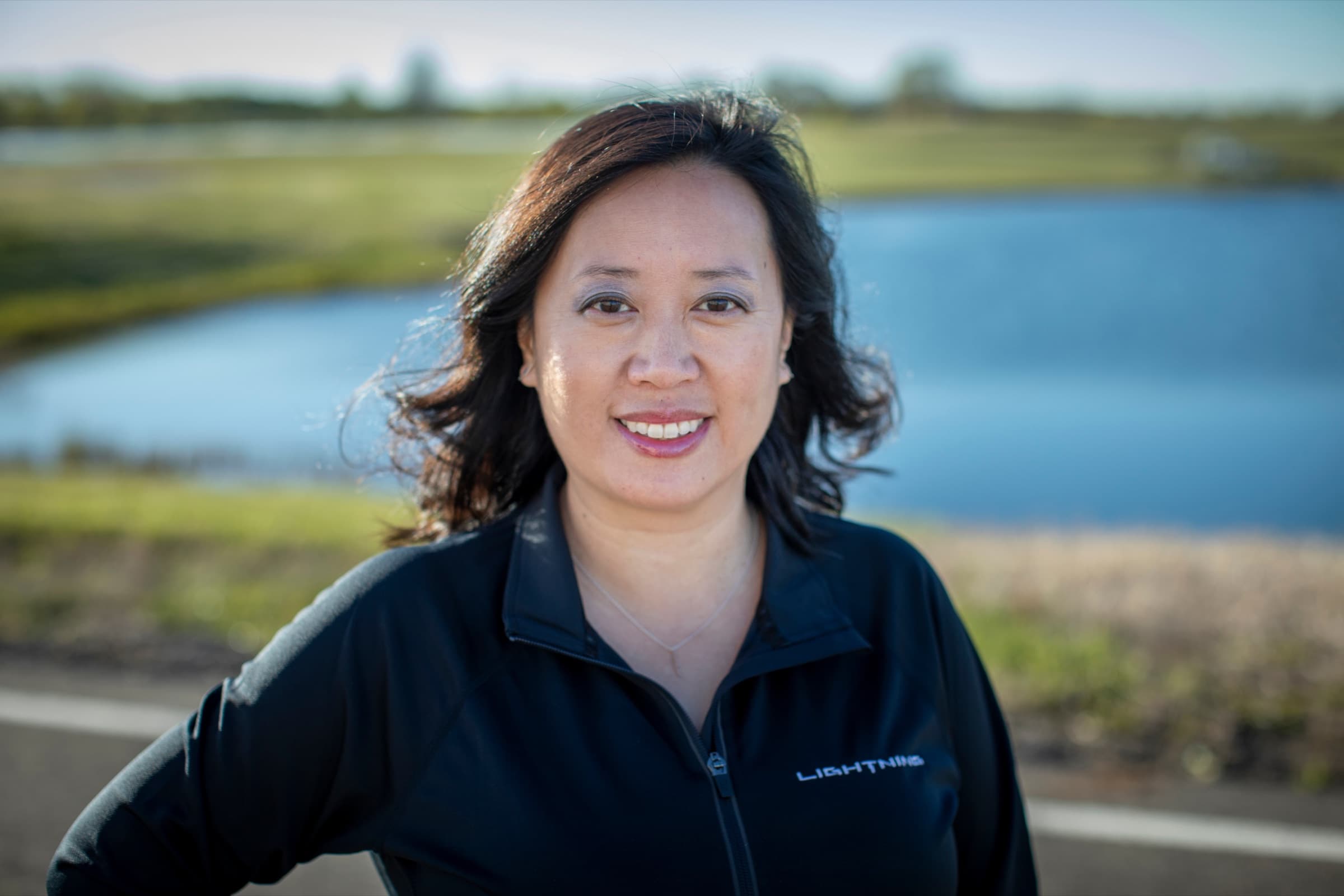 Linda Zhang, Ford F-150 Lightning chief engineer, in a Lightning zip-up outdoors