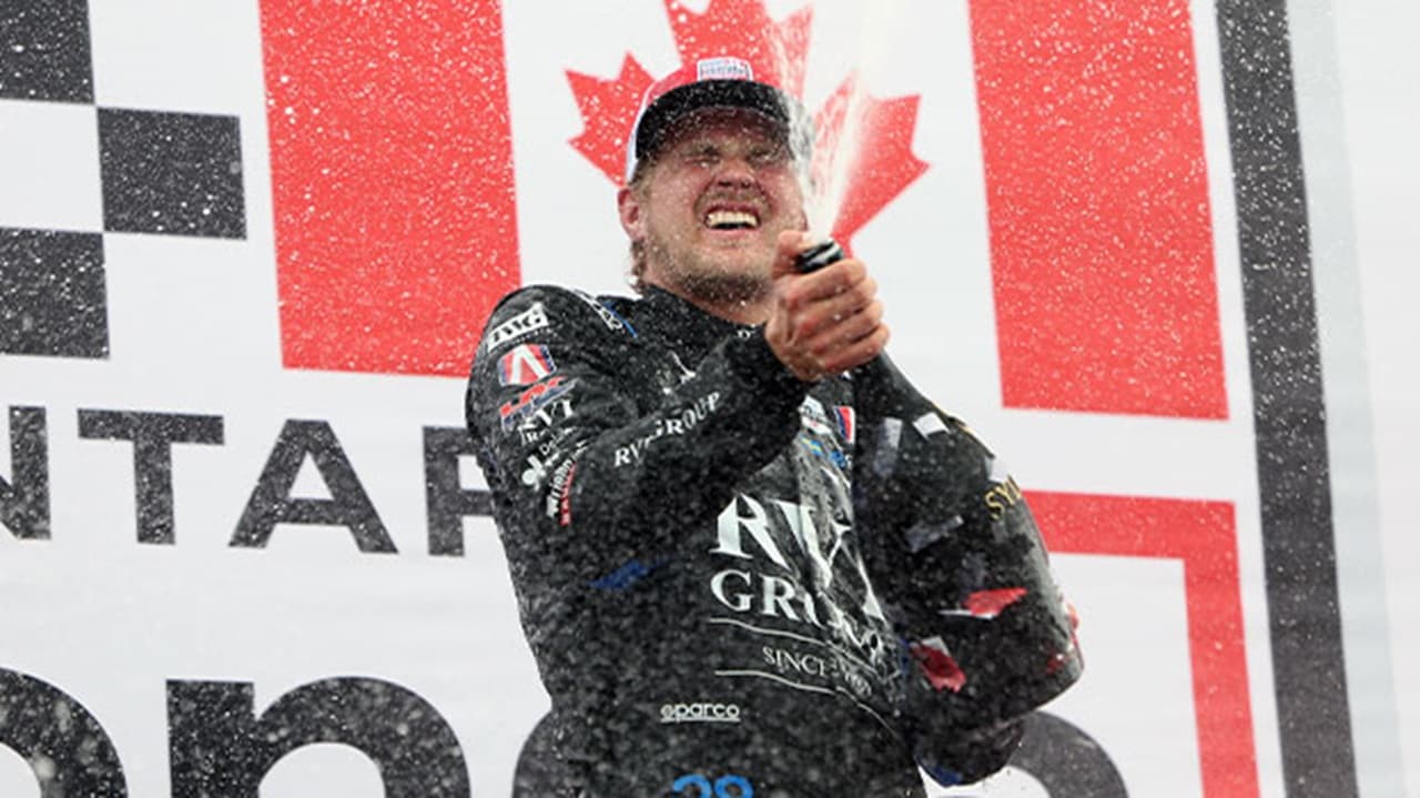 Marcus Ericsson sprays champagne on the podium after winning the 2026 Ontario Honda Dealers Indy at Markham