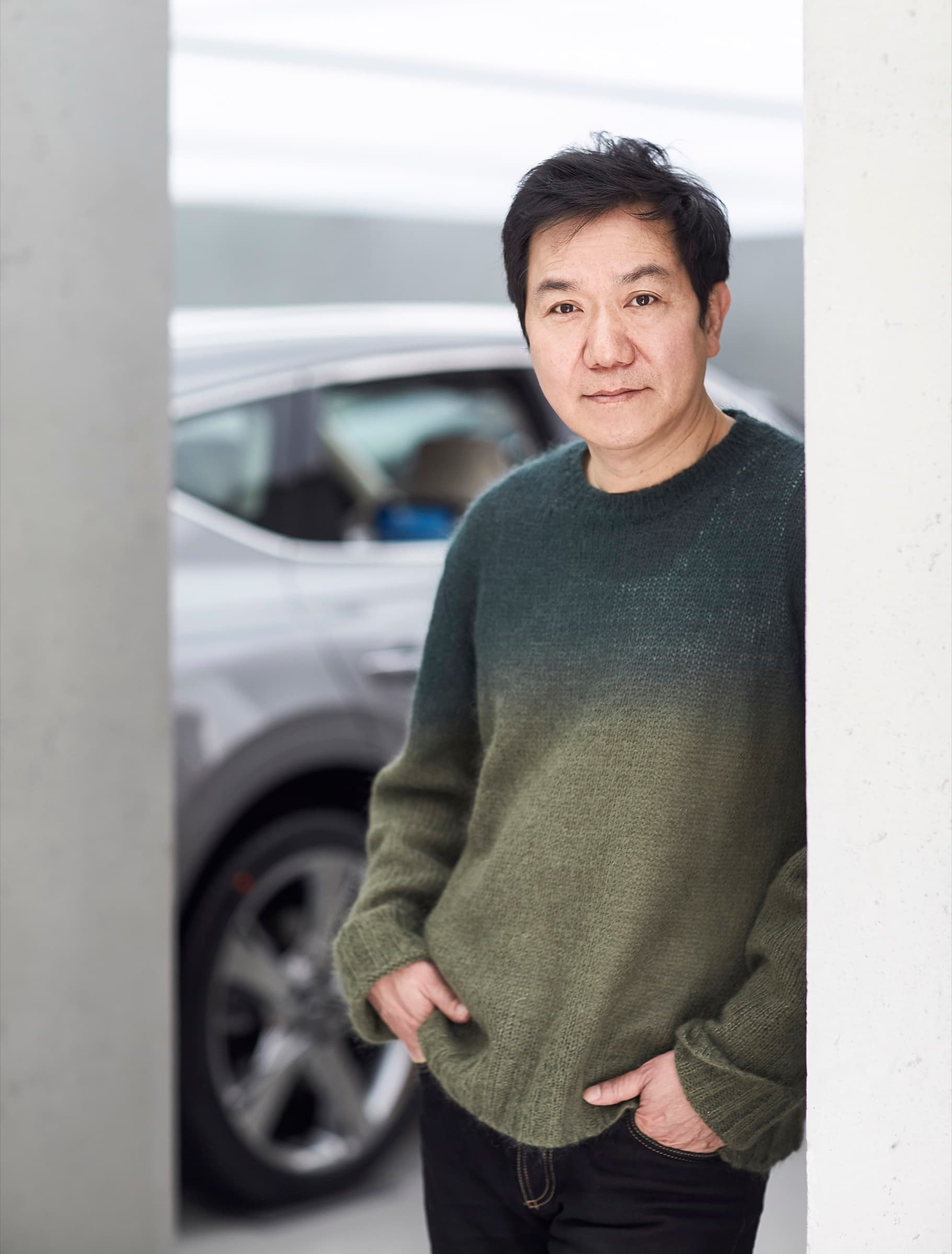 SangYup Lee, Hyundai and Genesis global design chief, standing beside a crossover in a white studio