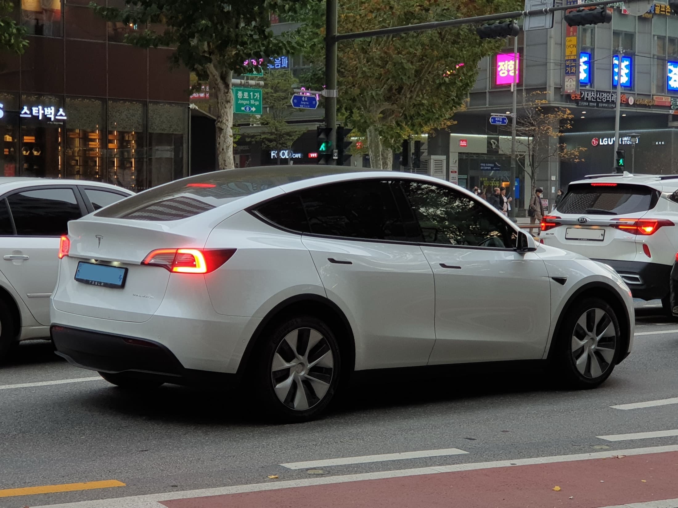 Pearl White Multi-Coat Tesla Model Y Dual Motor, front three-quarter view