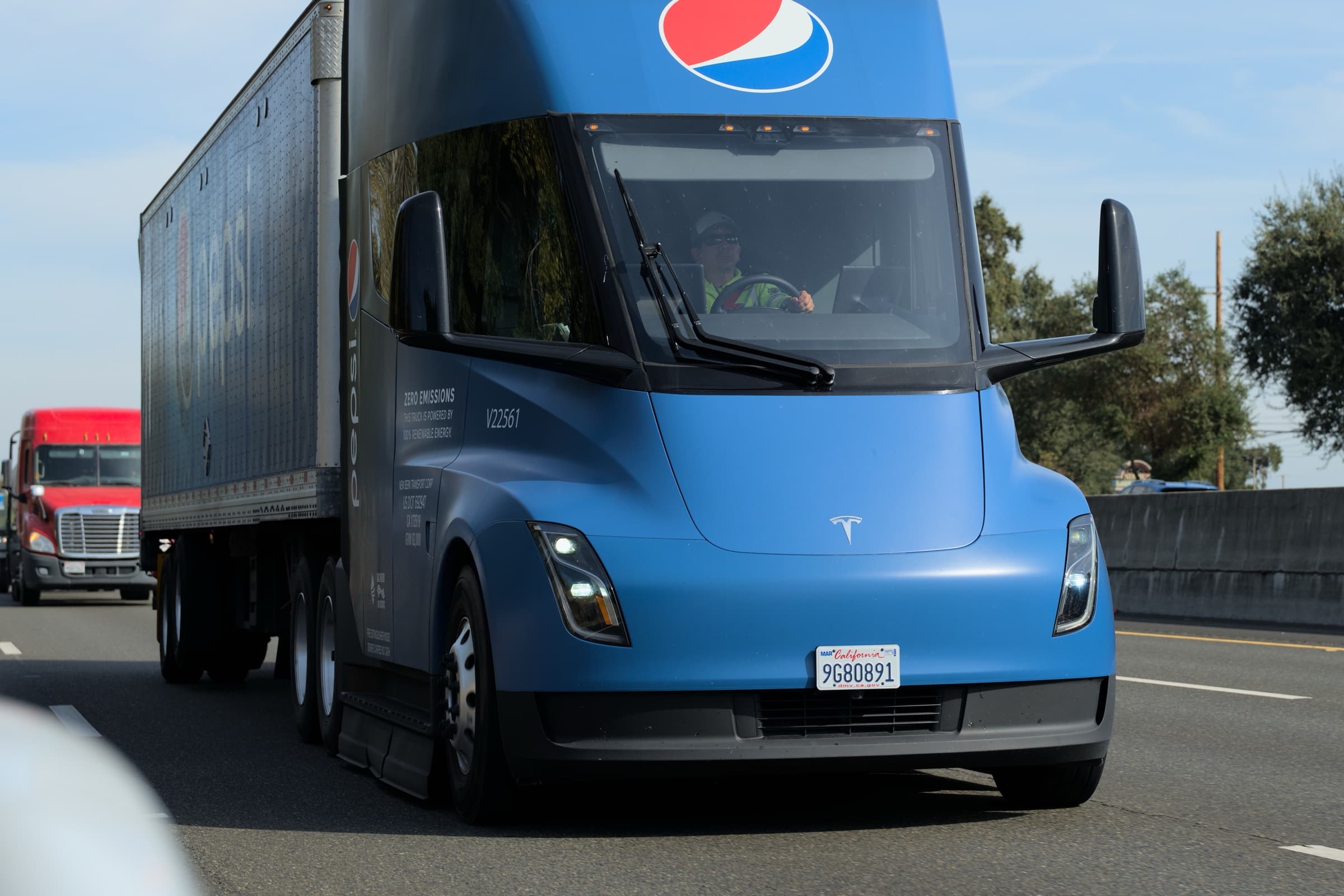 Blue Pepsi-operated Tesla Semi pulling a trailer on a California highway