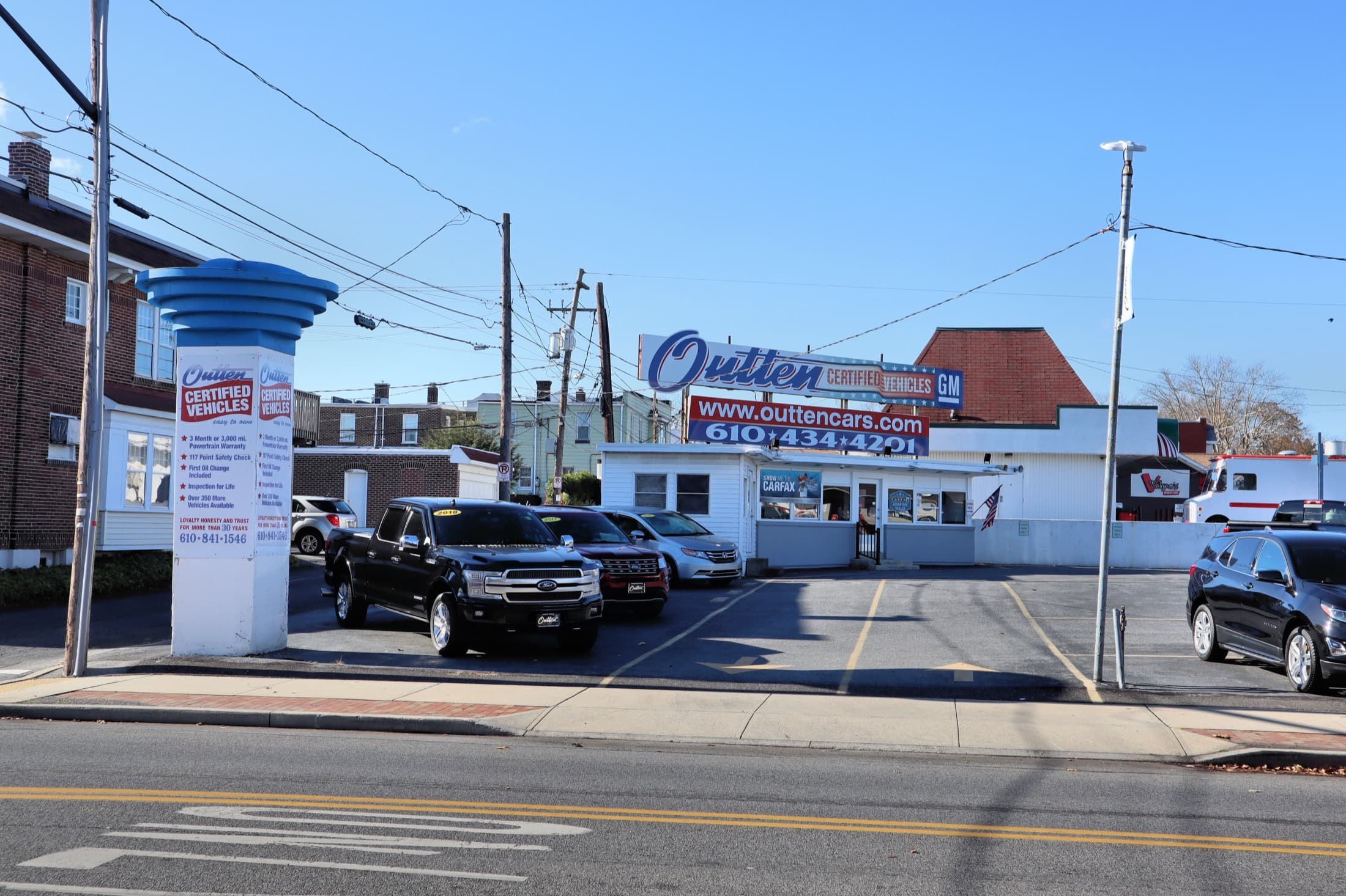 Rows of used cars on a dealership lot under blue sky in Allentown, Pennsylvania