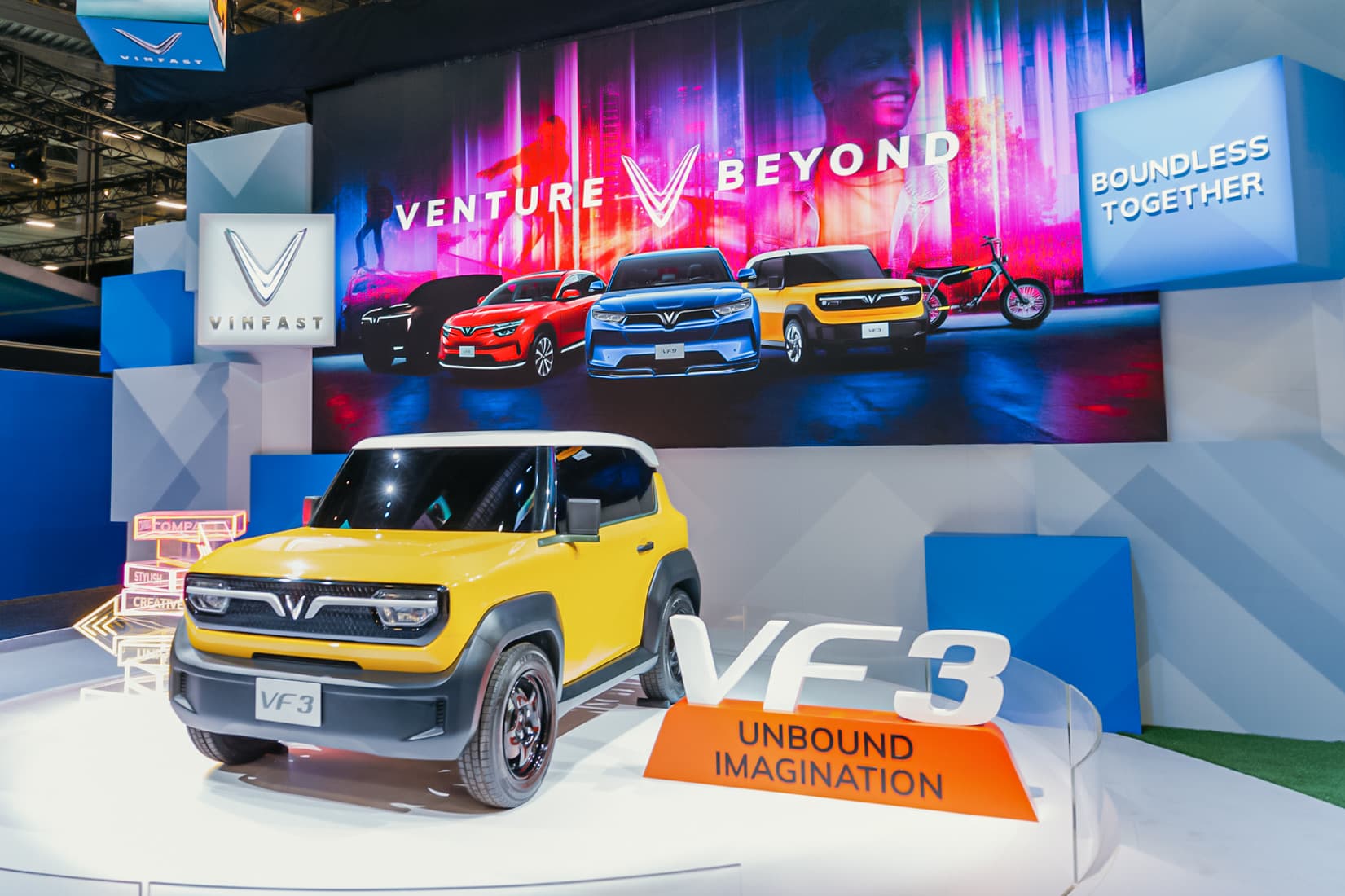 Yellow VinFast VF 3 mini electric SUV on display at the brand’s CES booth
