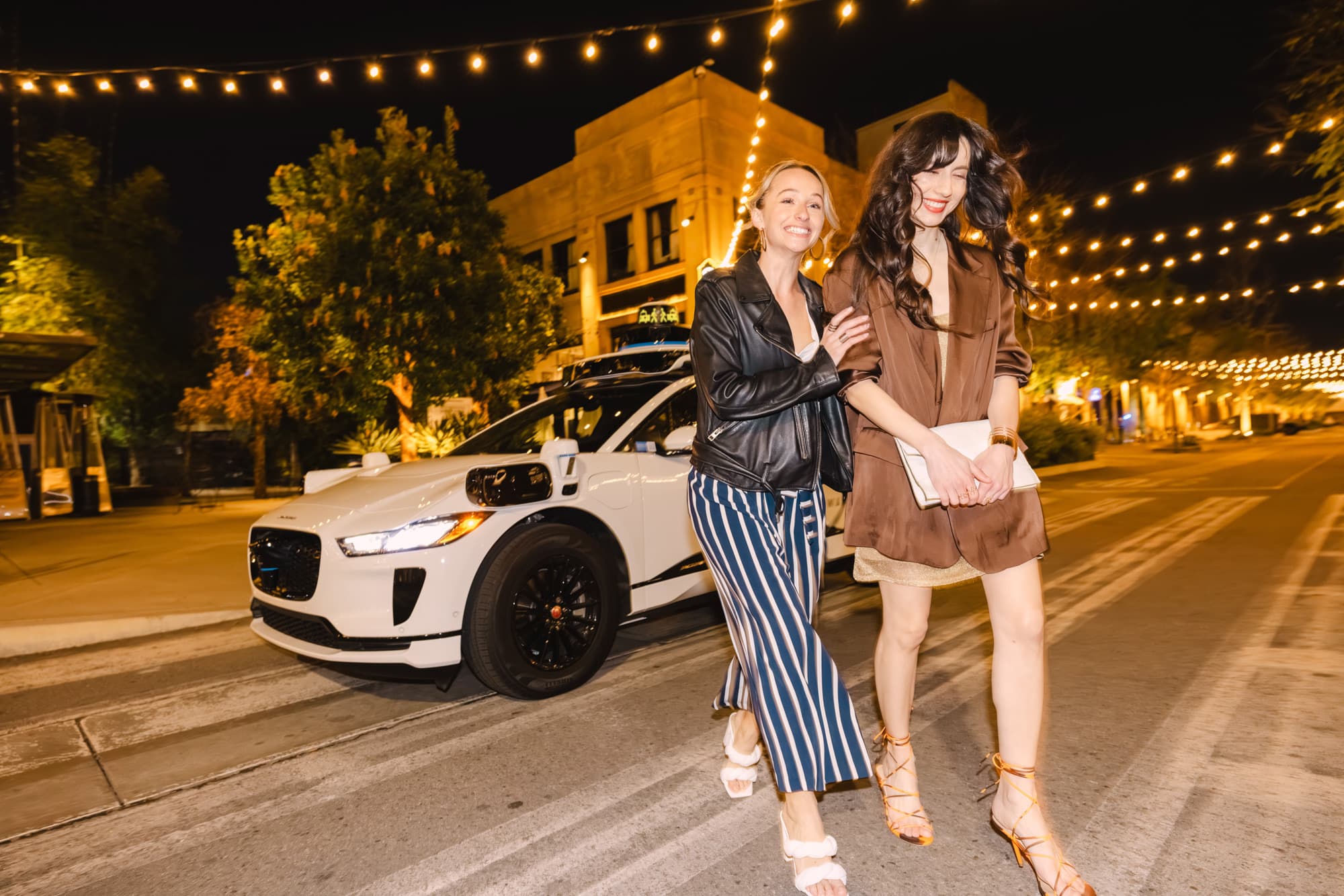 Waymo autonomous Jaguar I-PACE serving riders on a Los Angeles street