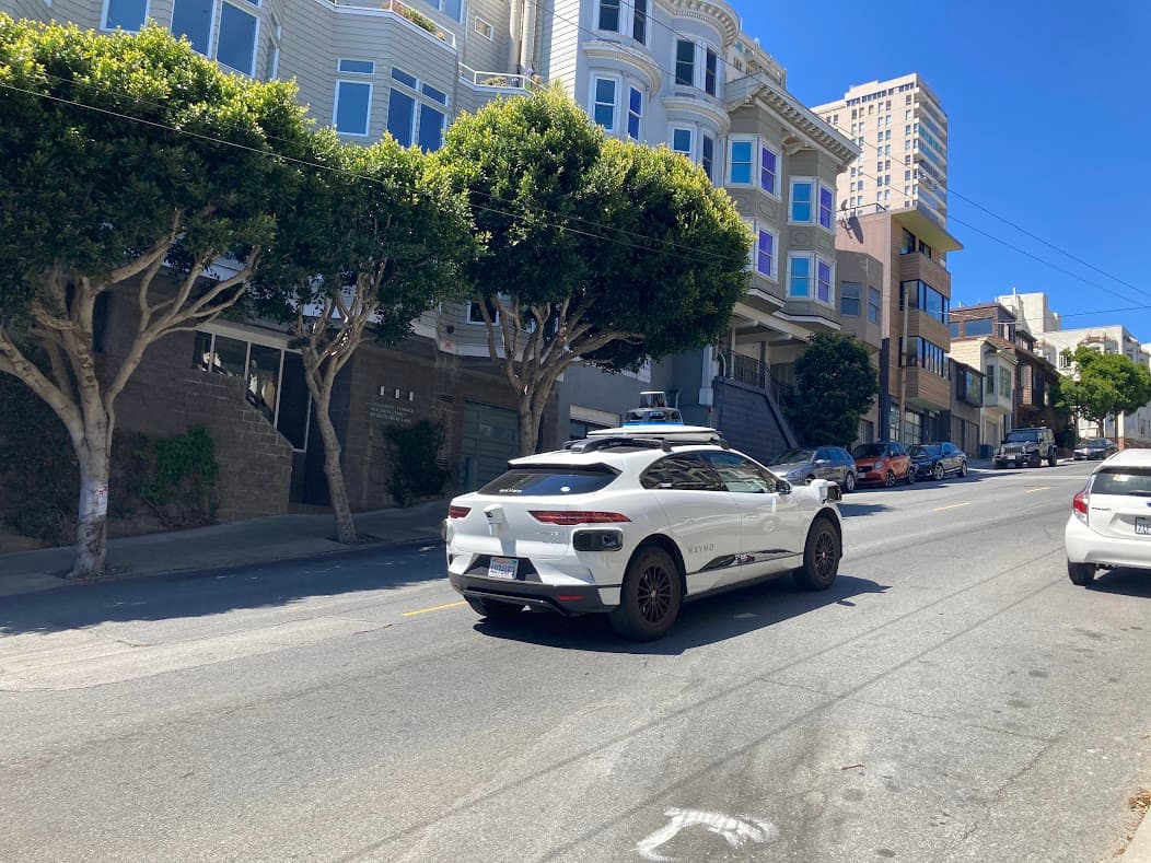 Waymo autonomous Jaguar I-Pace driving on a San Francisco residential street