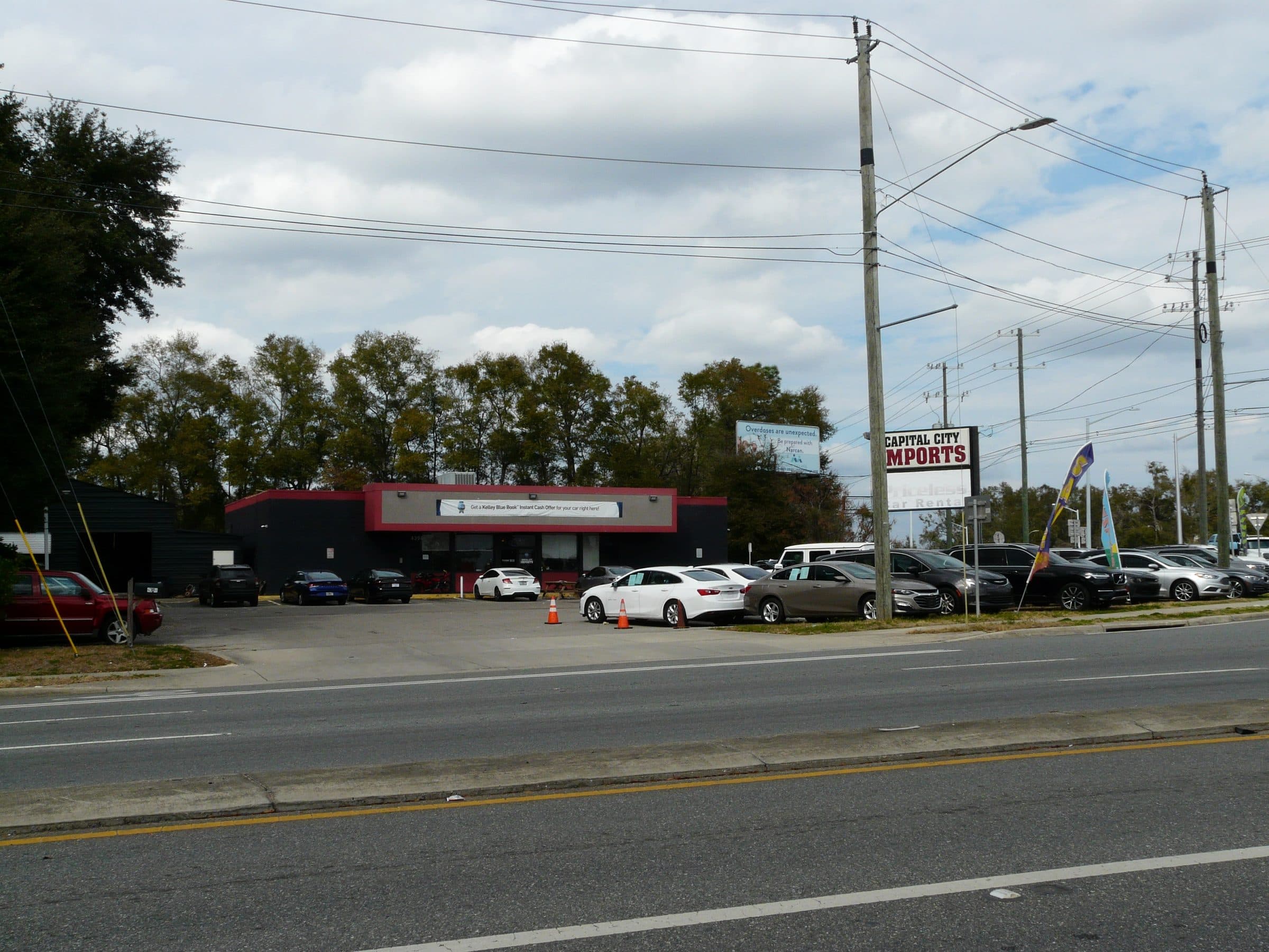 Cars parked at Capital City Imports dealership lot
