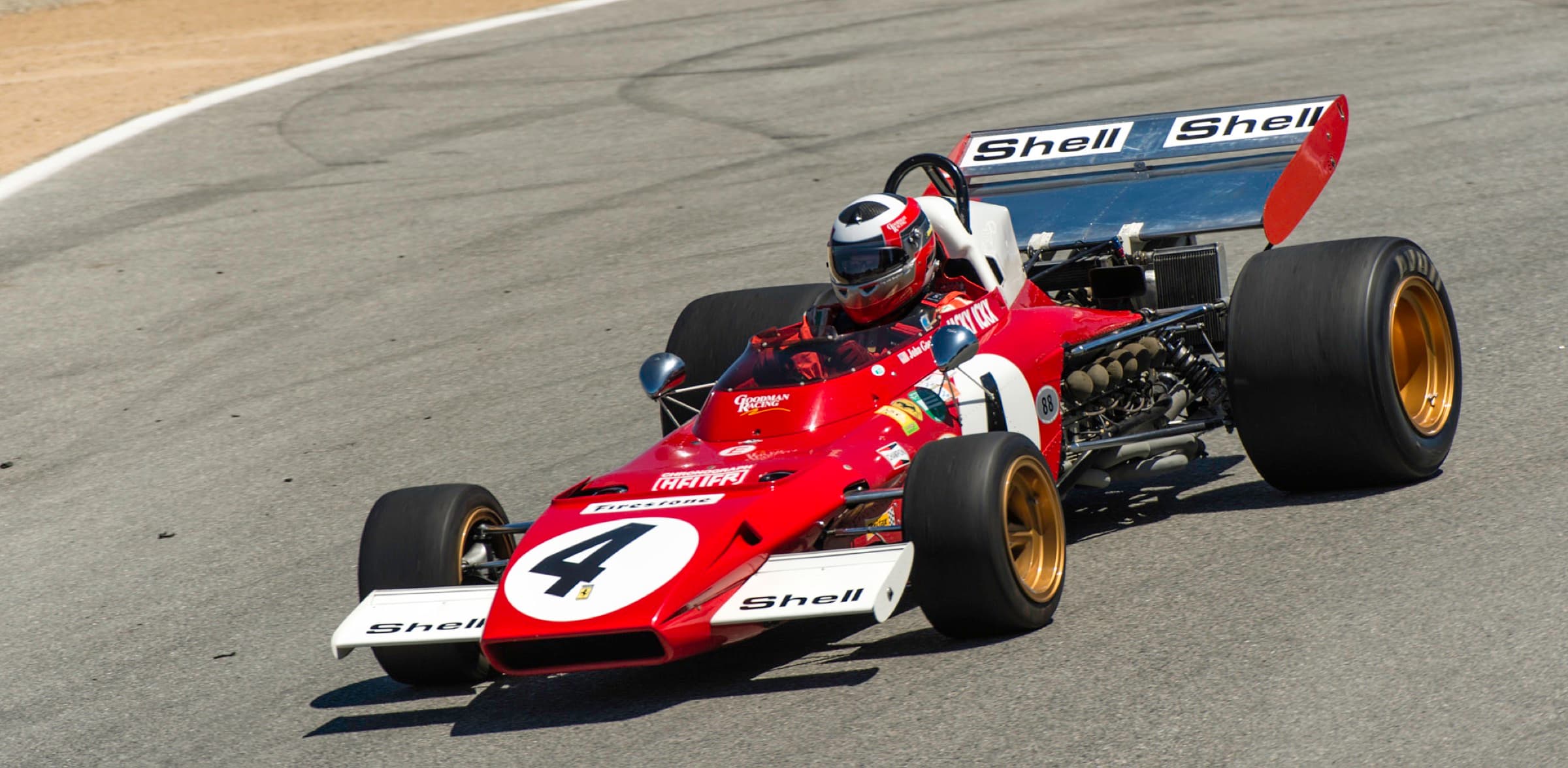 Historic Ferrari Formula One car descending Laguna Seca's Corkscrew