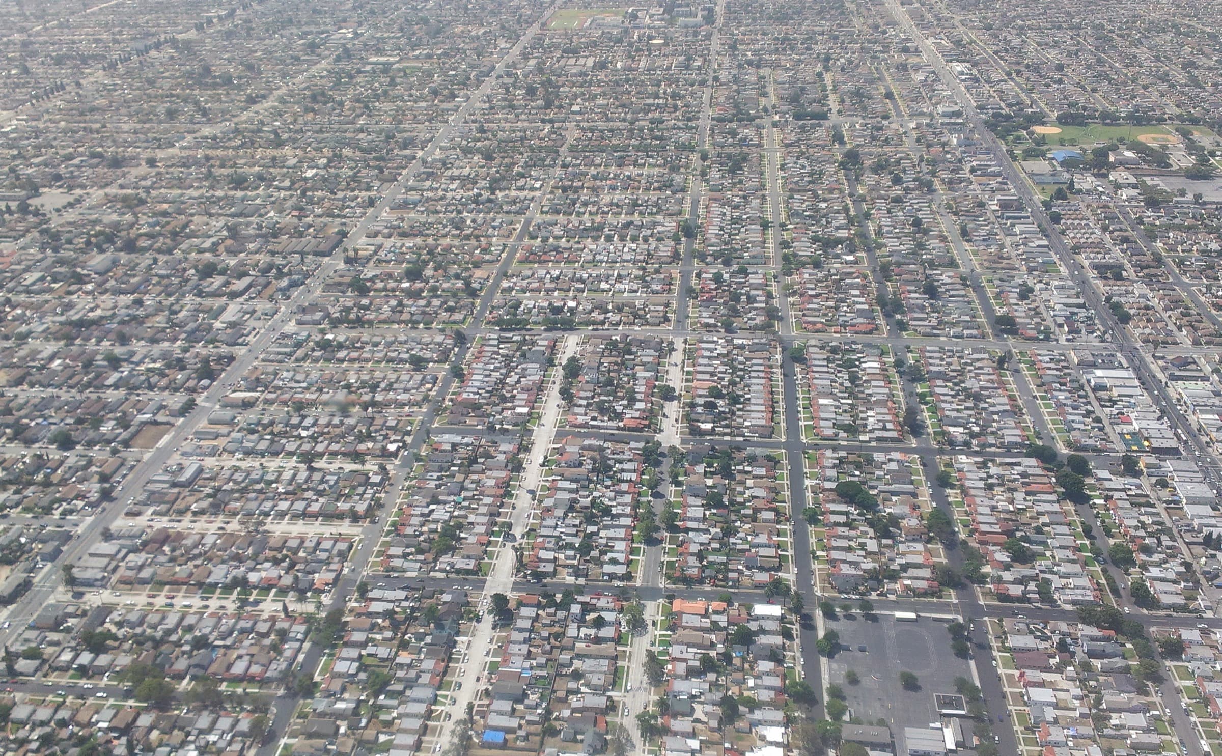 Aerial view of homes, streets, and parked cars in South Los Angeles