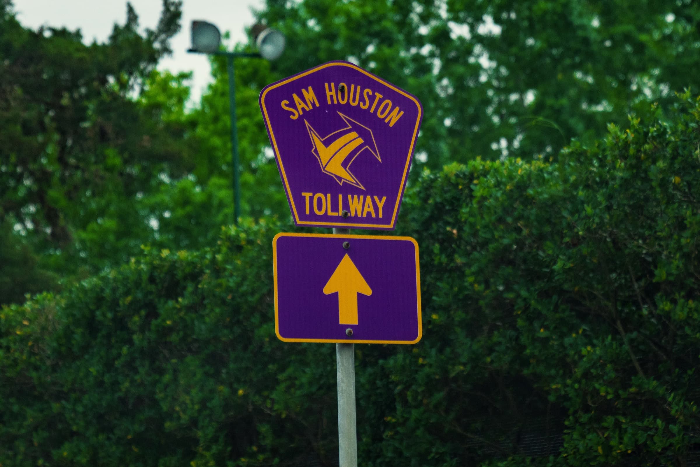 Sam Houston Tollway sign beside a Houston roadway
